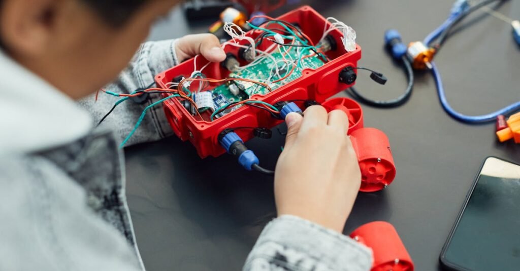 A child actively assembling a robotics project with electronic components, showcasing technology education.