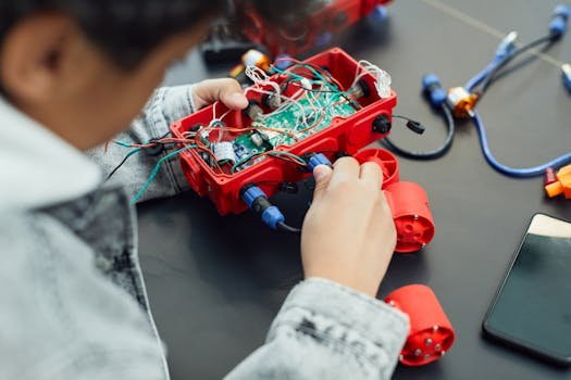 A child actively assembling a robotics project with electronic components, showcasing technology education.