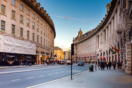 A bustling view of Regent Street in London with historic architecture and lively street life.